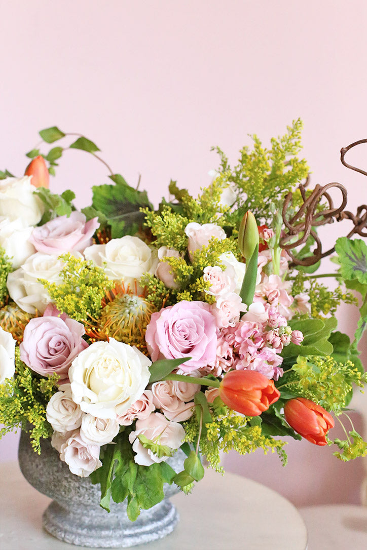 Close-up of blush roses, melon spray roses, stock, tulips and protea