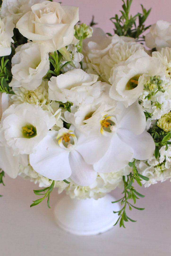 Close-up of creamy roses, white Phalaenopsis orchids, lisianthus and dahlias