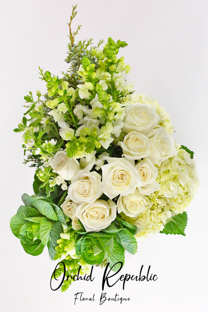 Close-up of white roses, cabbage roses, hydrangeas and tall snapdragon blooms