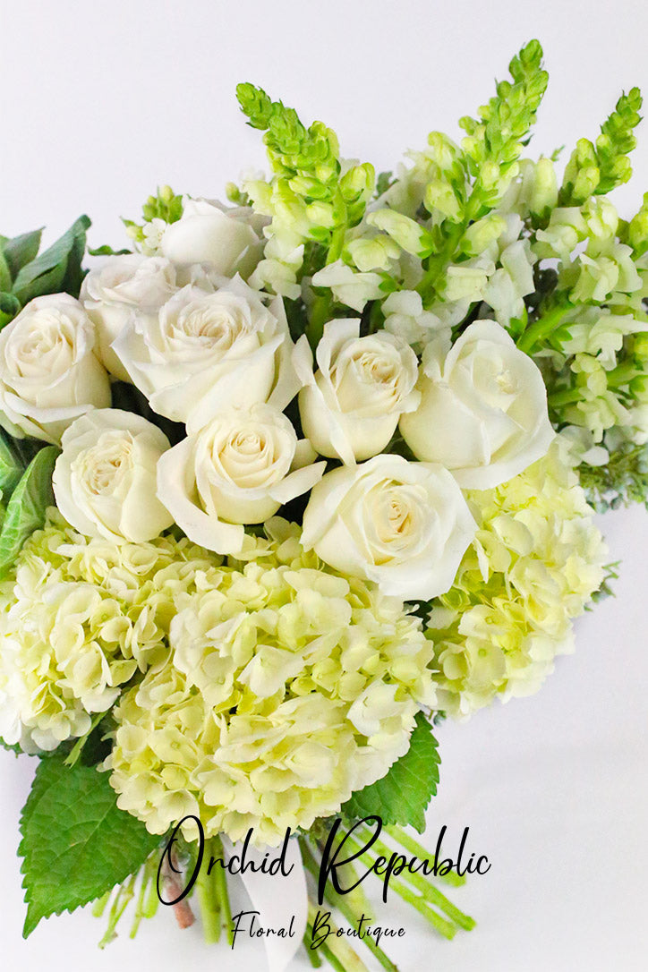 Close-up of white roses, cabbage roses, hydrangeas and tall snapdragon blooms