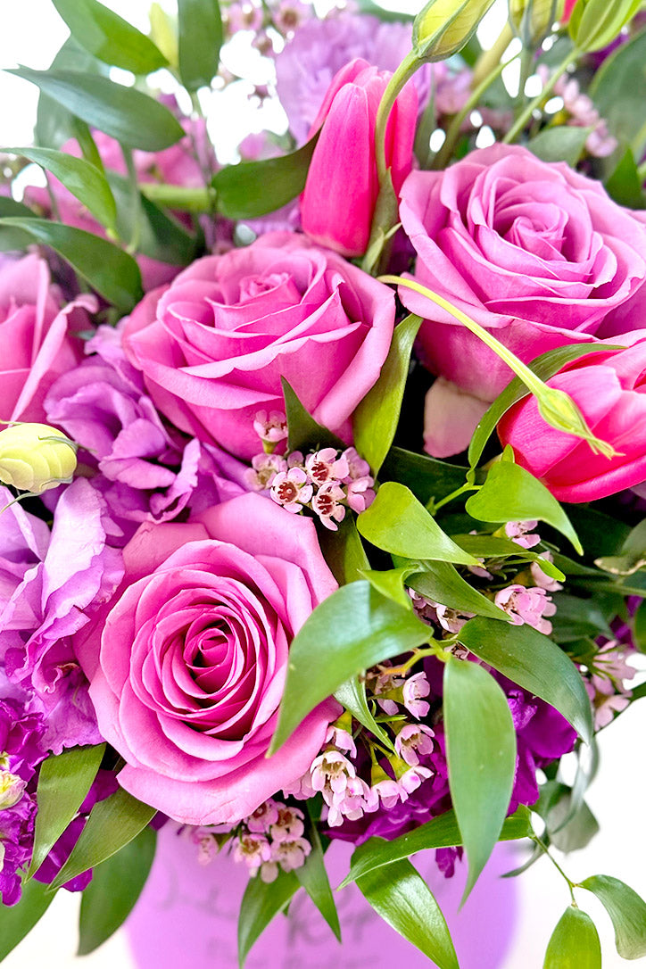 Close-up of Cool Water roses, pink tulips, purple stock and lavender lisianthus