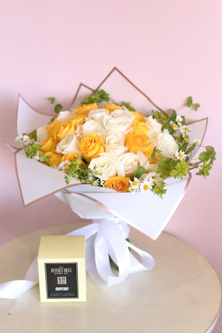 White and yellow rose hand bouquet with cheerful white daisies