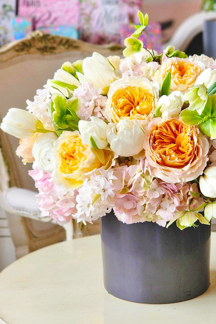 Side view of peach roses, hyacinths and hydrangeas with green hellebores