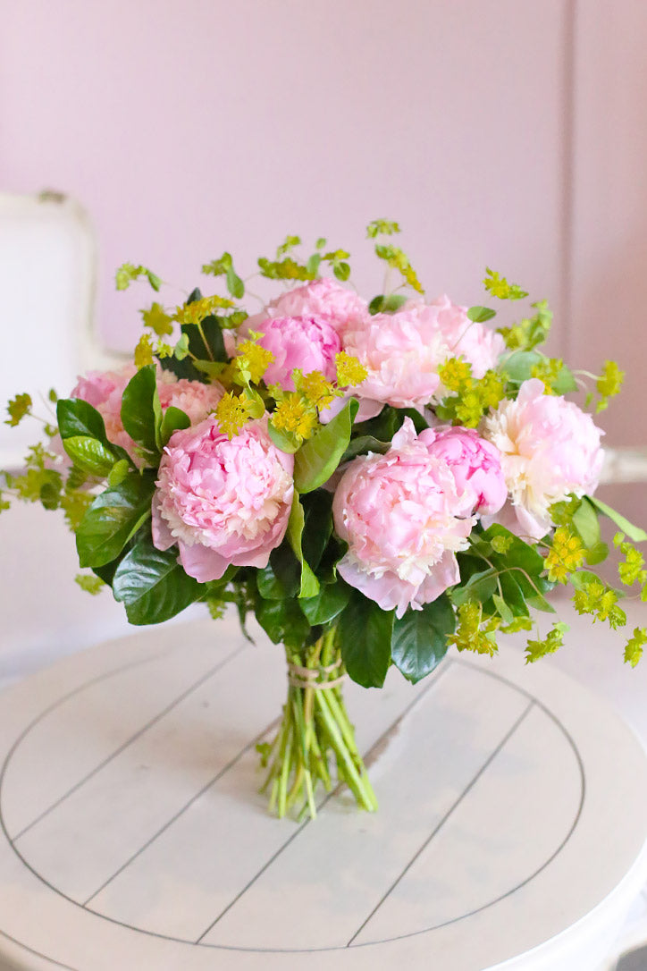Lush pink peony bouquet accented with pittosporum greenery and gardenia leaves