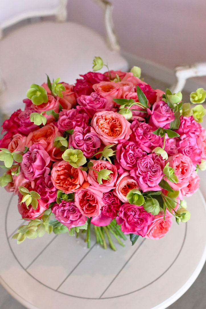 Full rose hand bouquet showing soft romantic colors and layered premium wrapping