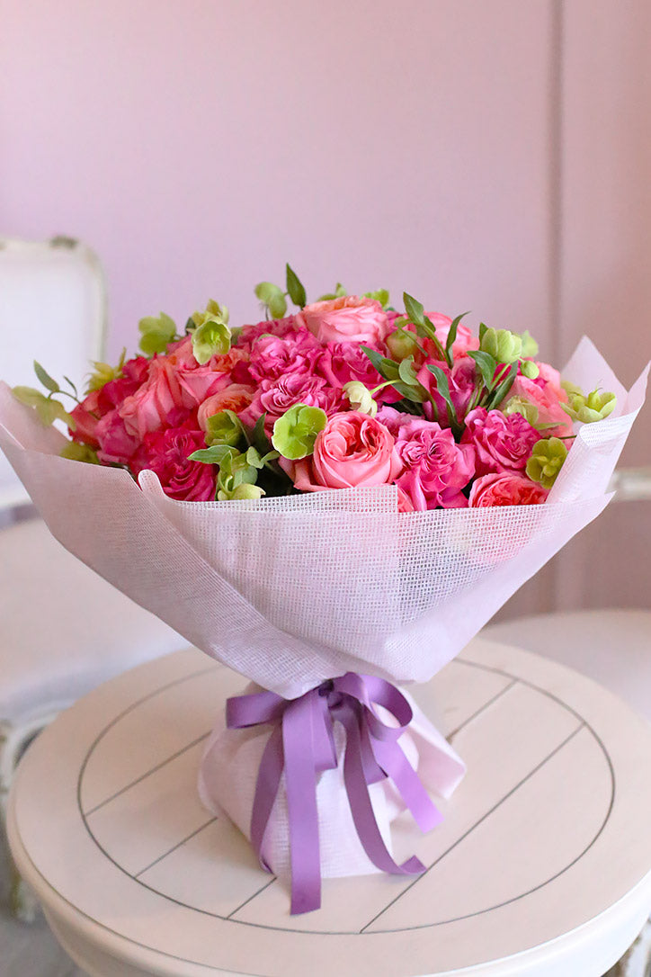 Pink Xpression and Country Blues rose bouquet with green hellebores in premium wrapping