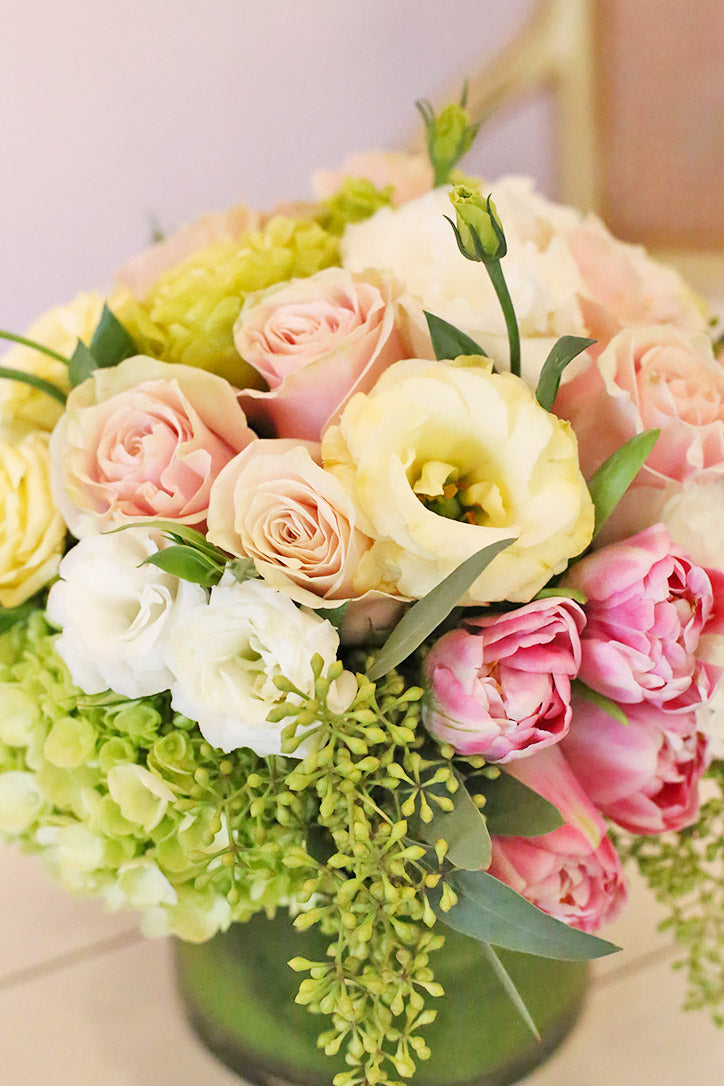 Close-up of pink roses, cream tulips, lisianthus and apple green hydrangeas