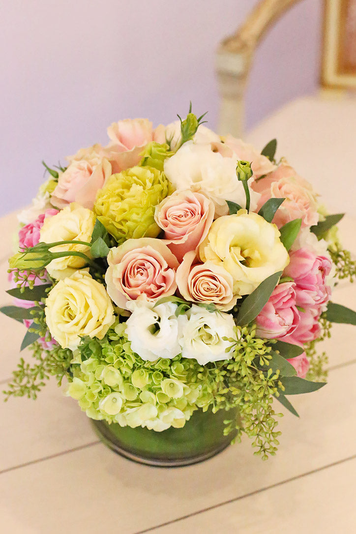Spring-hued roses, lisianthus, tulips, and hydrangeas in apple green, pink, and cream