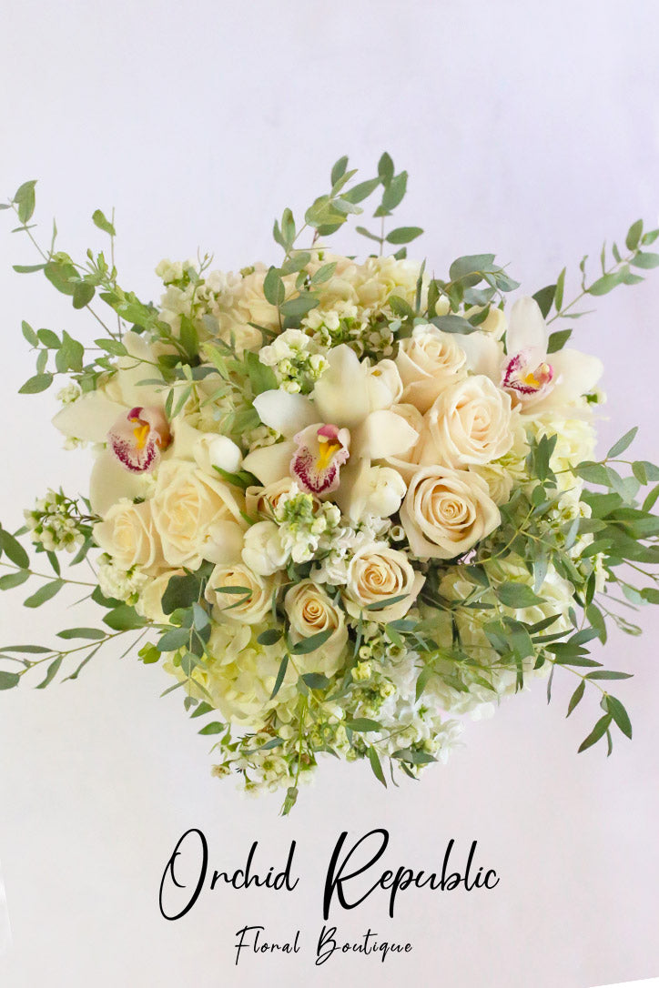 Close-up of white roses, tulips, hydrangeas and creamy Cymbidium orchid blooms