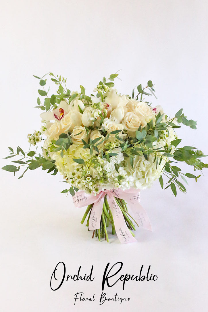 Creamy white rose, tulip and hydrangea bouquet with white Cymbidium orchids