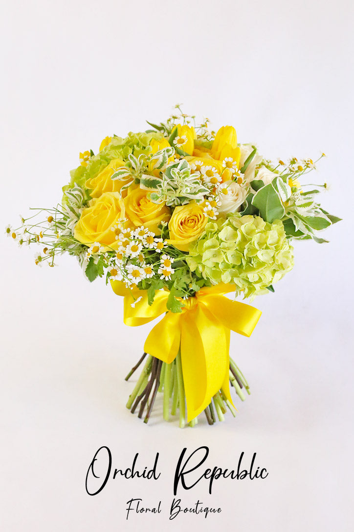 Hand bouquet wrapped in fine-quality paper and tied with a decorative ribbon