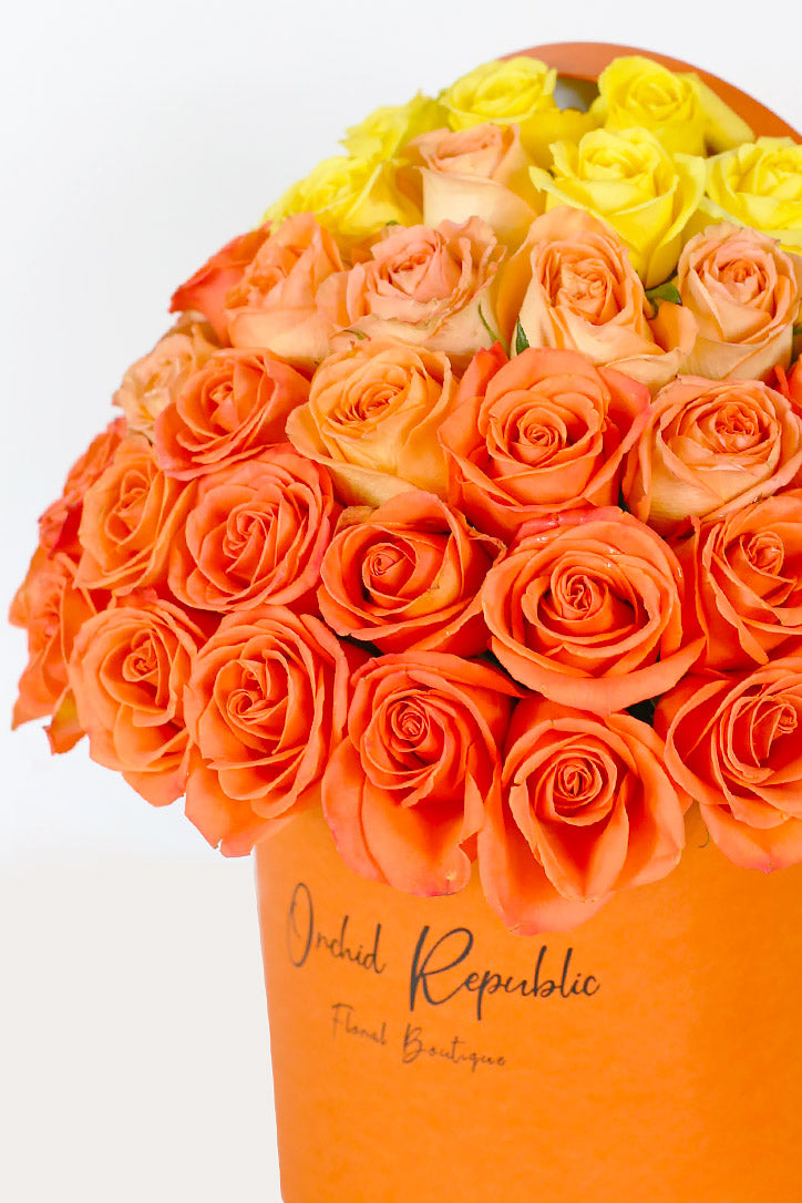 Close-up of orange, peach and yellow roses in a warm monochromatic design