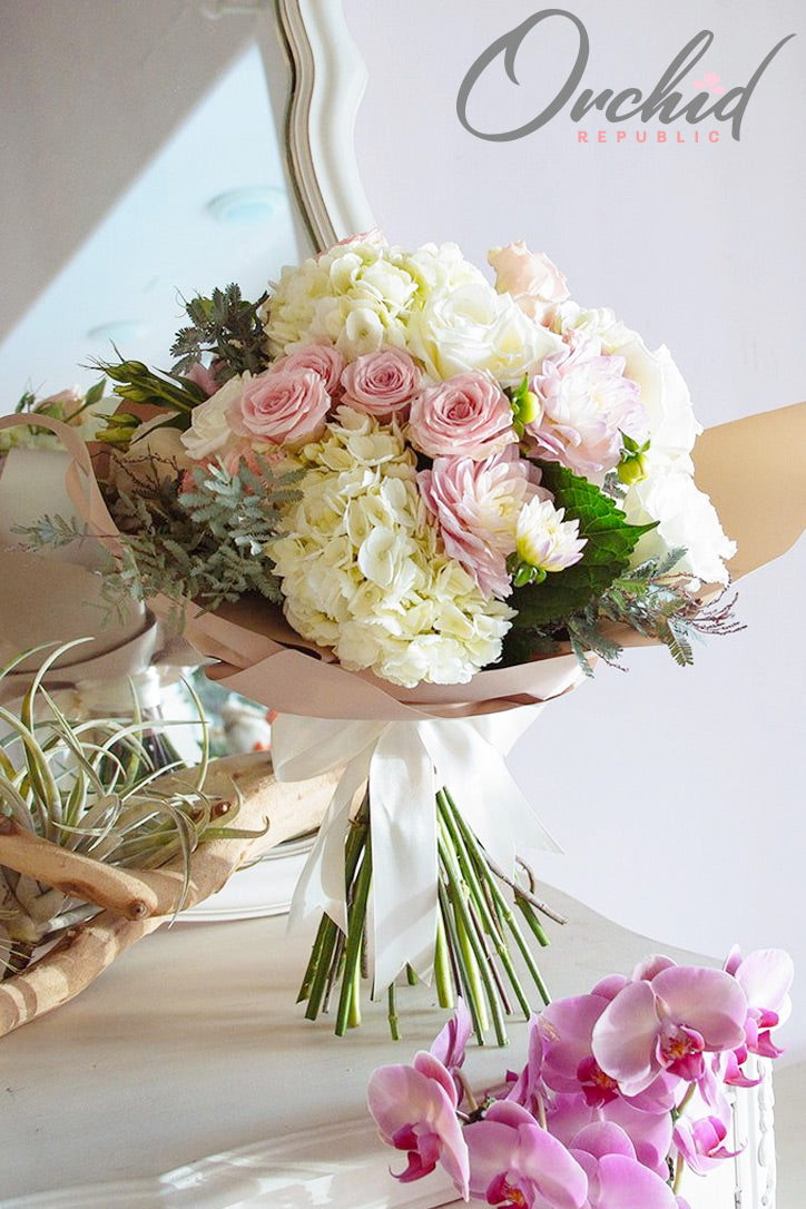 Pink and white dahlia, rose and Phalaenopsis orchid bouquet with hydrangeas