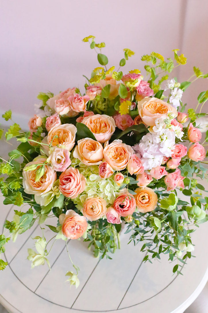 Close-up of Juliet roses, spray roses, lisianthus, hellebores and hydrangeas