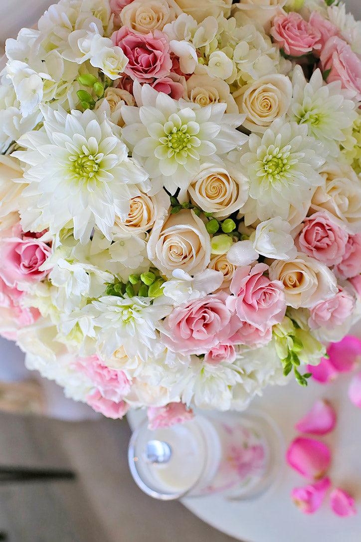 Close-up of creamy hydrangeas, white dahlias, peach roses and blush roses