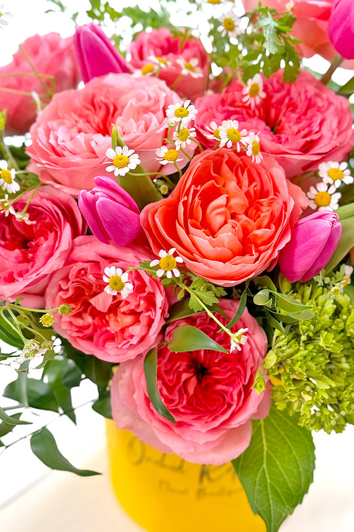 Close-up of coral Mandarin roses, pink tulips, chamomile and green hydrangeas